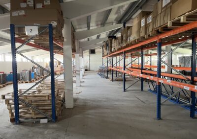 In interiorul unui depozit industrial de la Parcul Industrial Areli Vetis Satu Mare sunt stivuite rafturi cu cutii